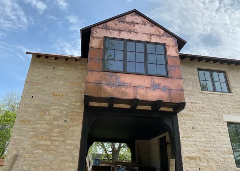 Copper metal panel facade on a stone building for Metal Roof Coating in Bartlett